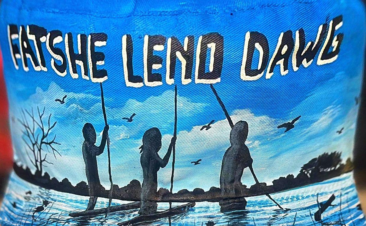 Three canoeing silhouettes under blue sky and white lettering.