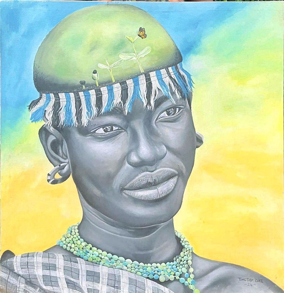 Woman wearing a beaded necklace and a green head covering with striped fringe.