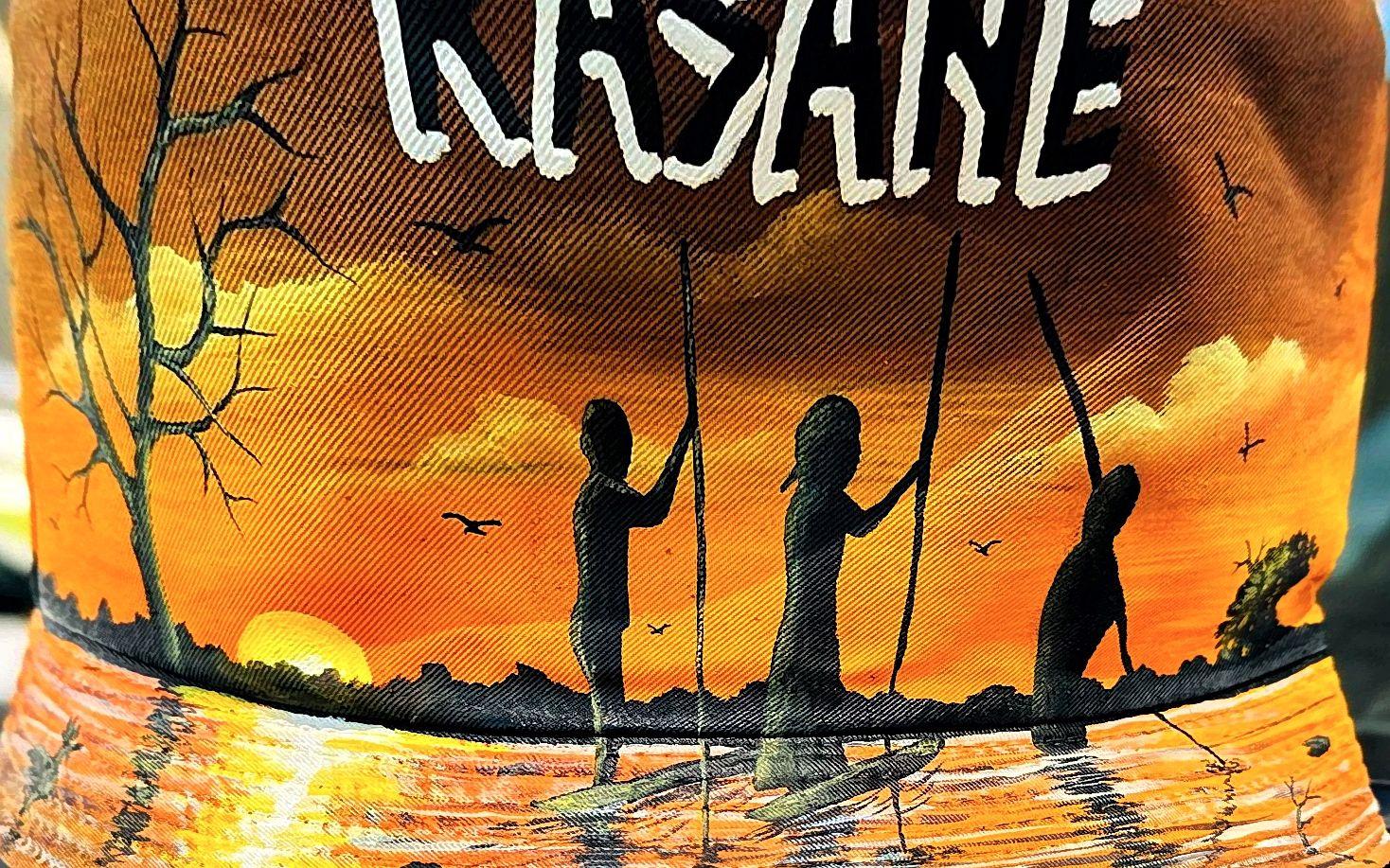 Three canoeing silhouettes reflected in orange water beneath white lettering.