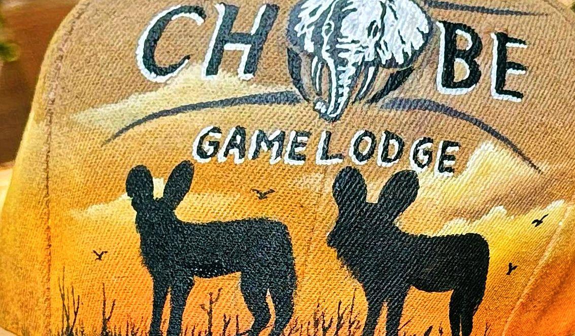 Two animal silhouettes on orange fabric below an elephant emblem and lettering.