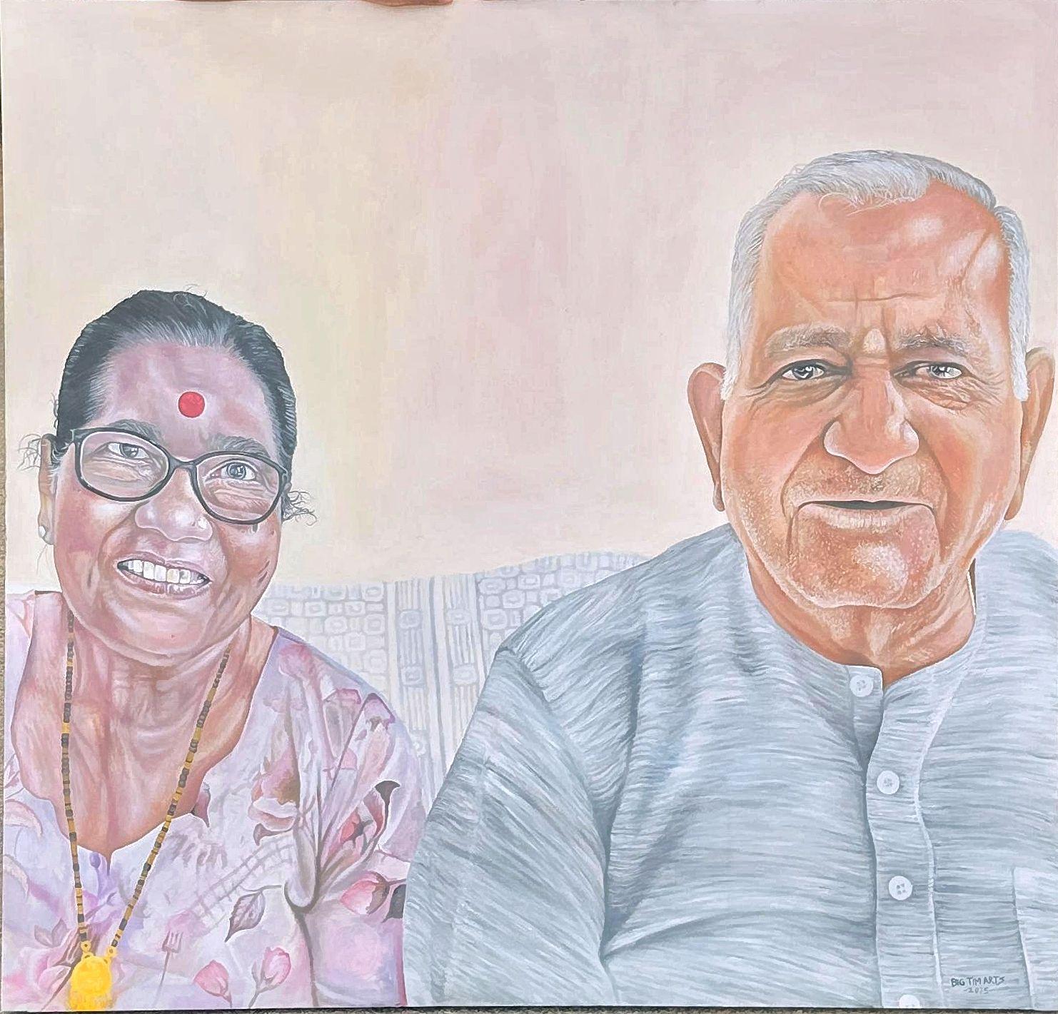 Two older adults seated together, one wearing glasses and a pink patterned blouse.