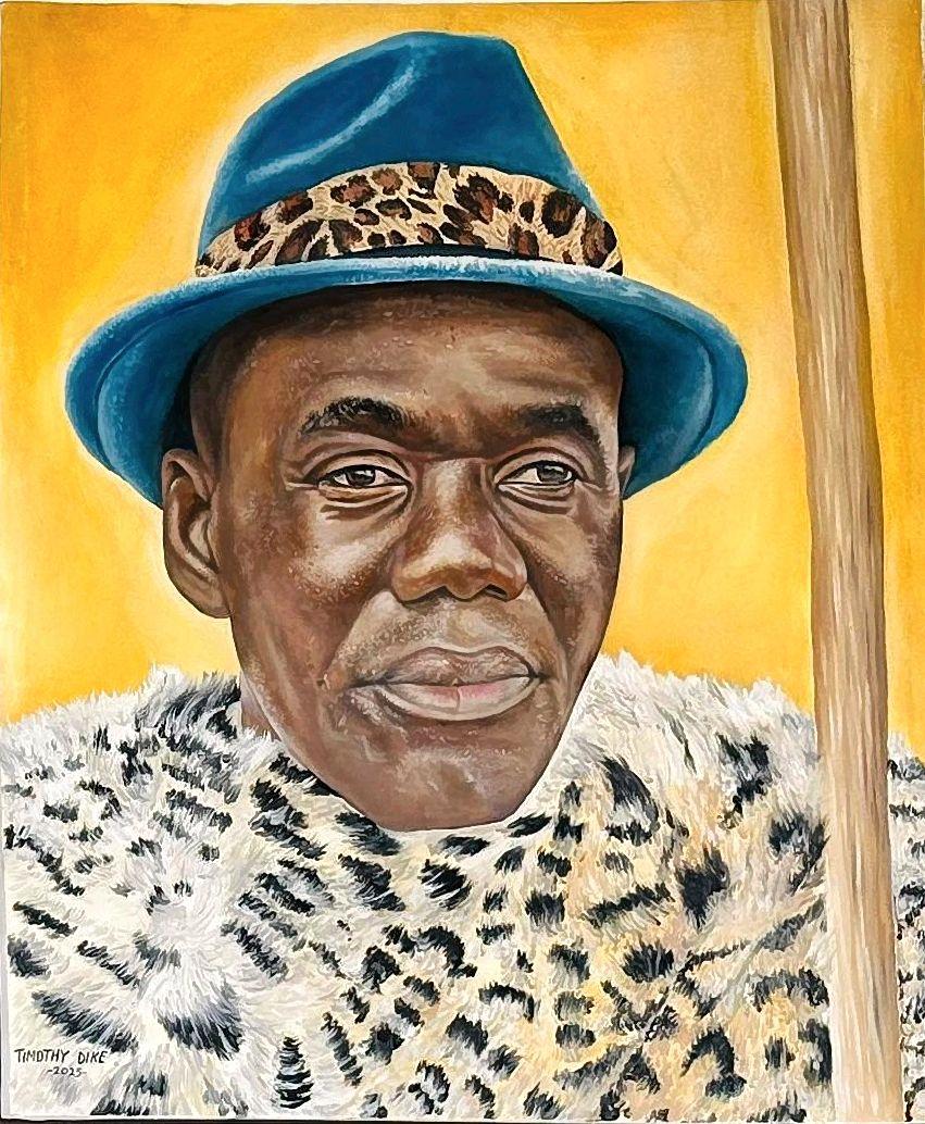 Man in a blue hat with a spotted hatband and matching spotted garment.