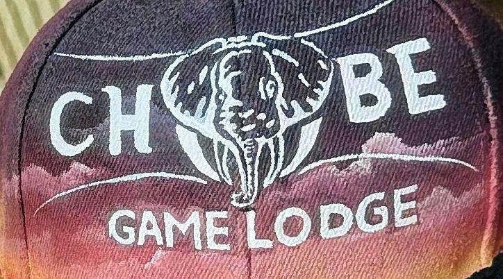 White elephant emblem and lodge lettering painted on dark fabric.