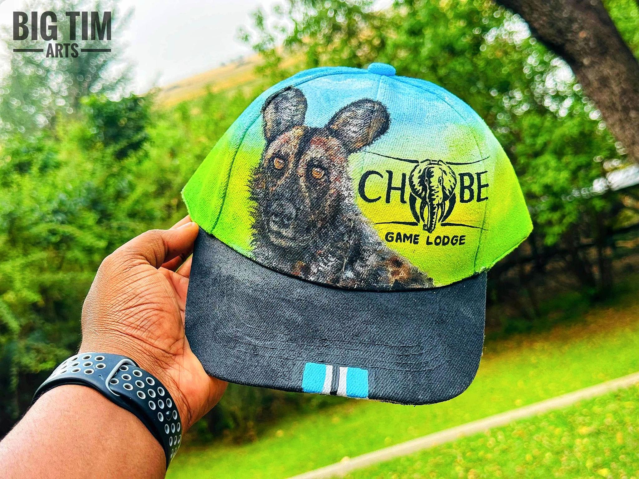 Green and blue cap painted with a spotted animal face and lodge lettering.