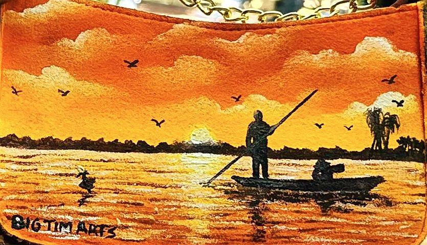 Figures in a small boat crossing orange sunset water.