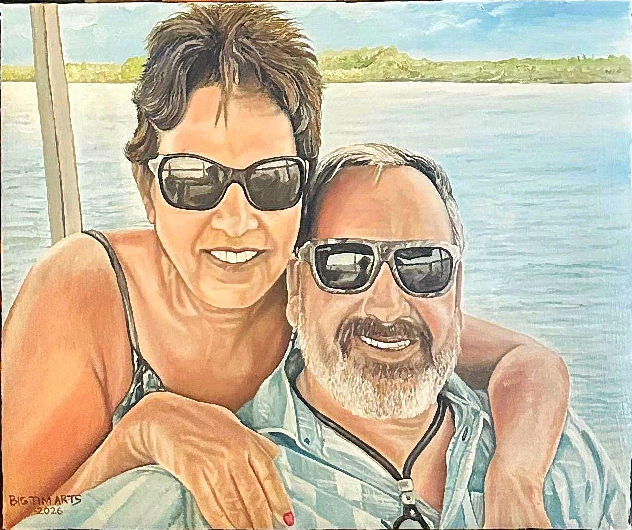 Two smiling people wearing sunglasses beside pale blue water.