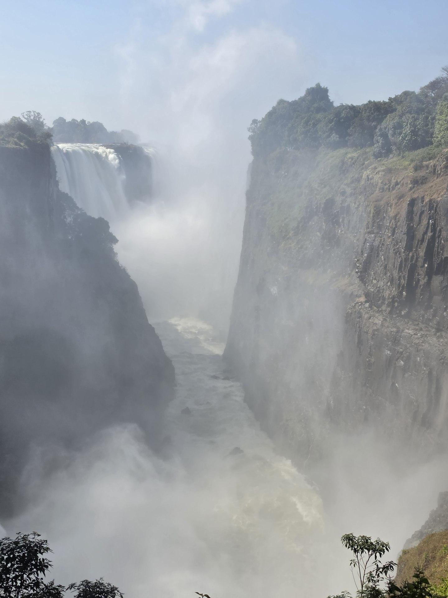 Water and mist fill the narrow gorge between rock walls.